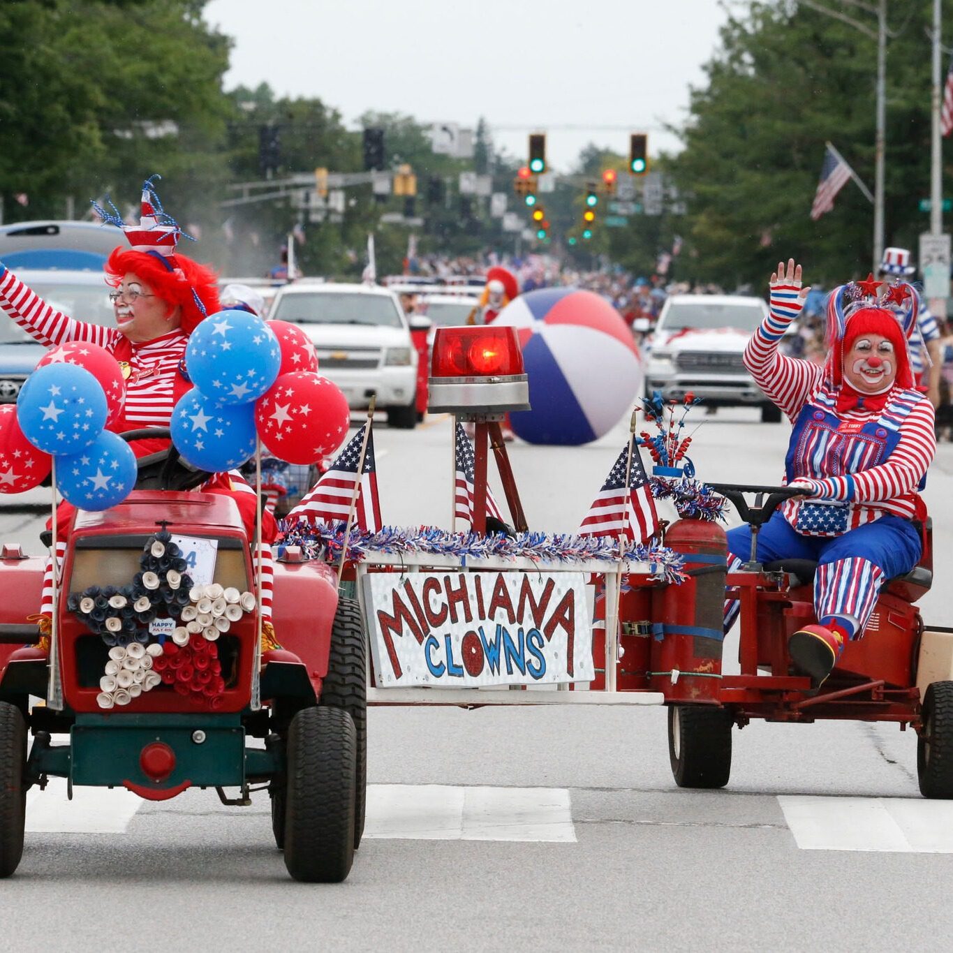 Michiana Clowns riding decorated mini tractors and waving American flags at the Kiwanis Fourth of July Parade in LaPorte, Indiana.